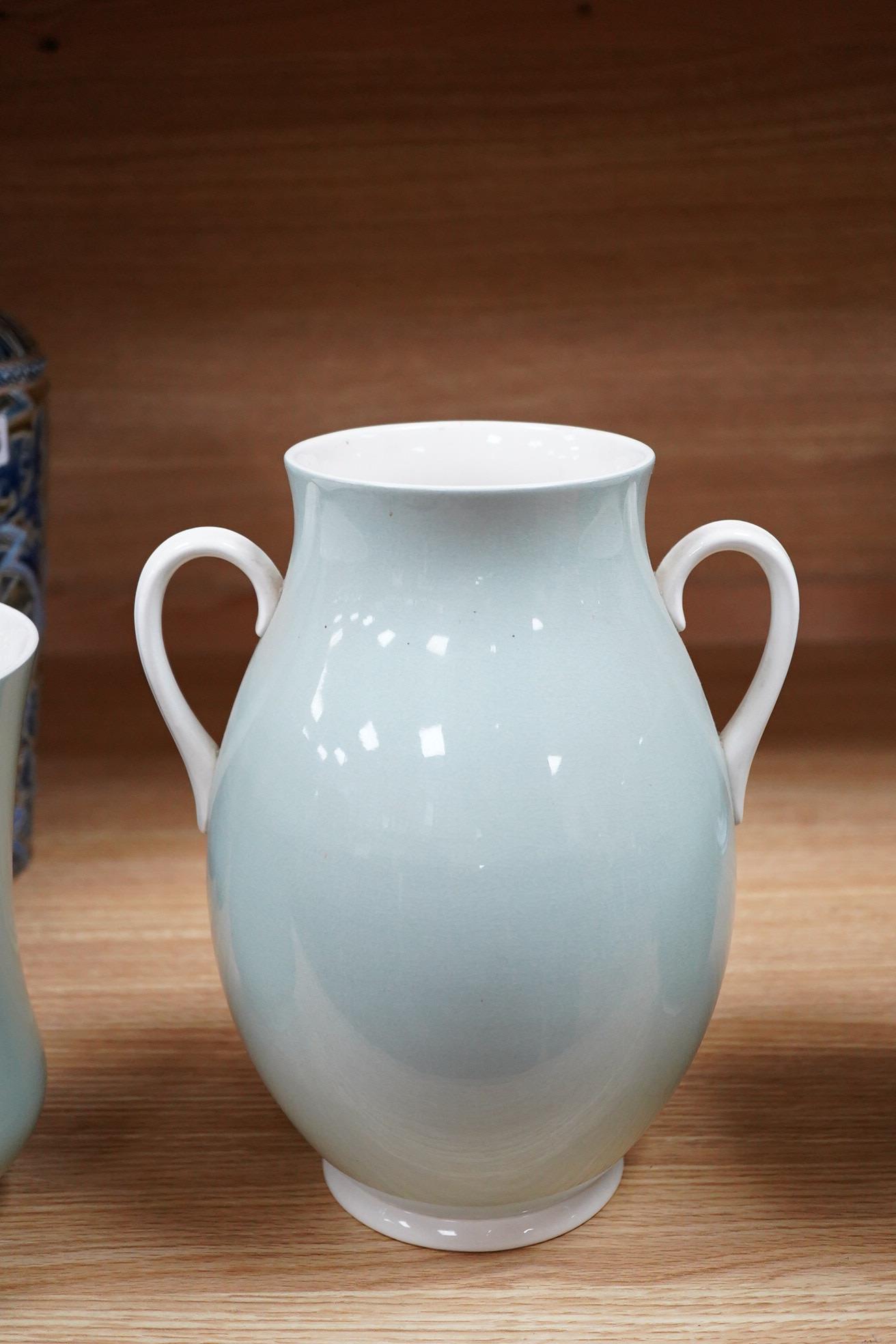Keith Murray for Wedgwood, three celadon slipware vases, one with twin handles, largest 27cm high